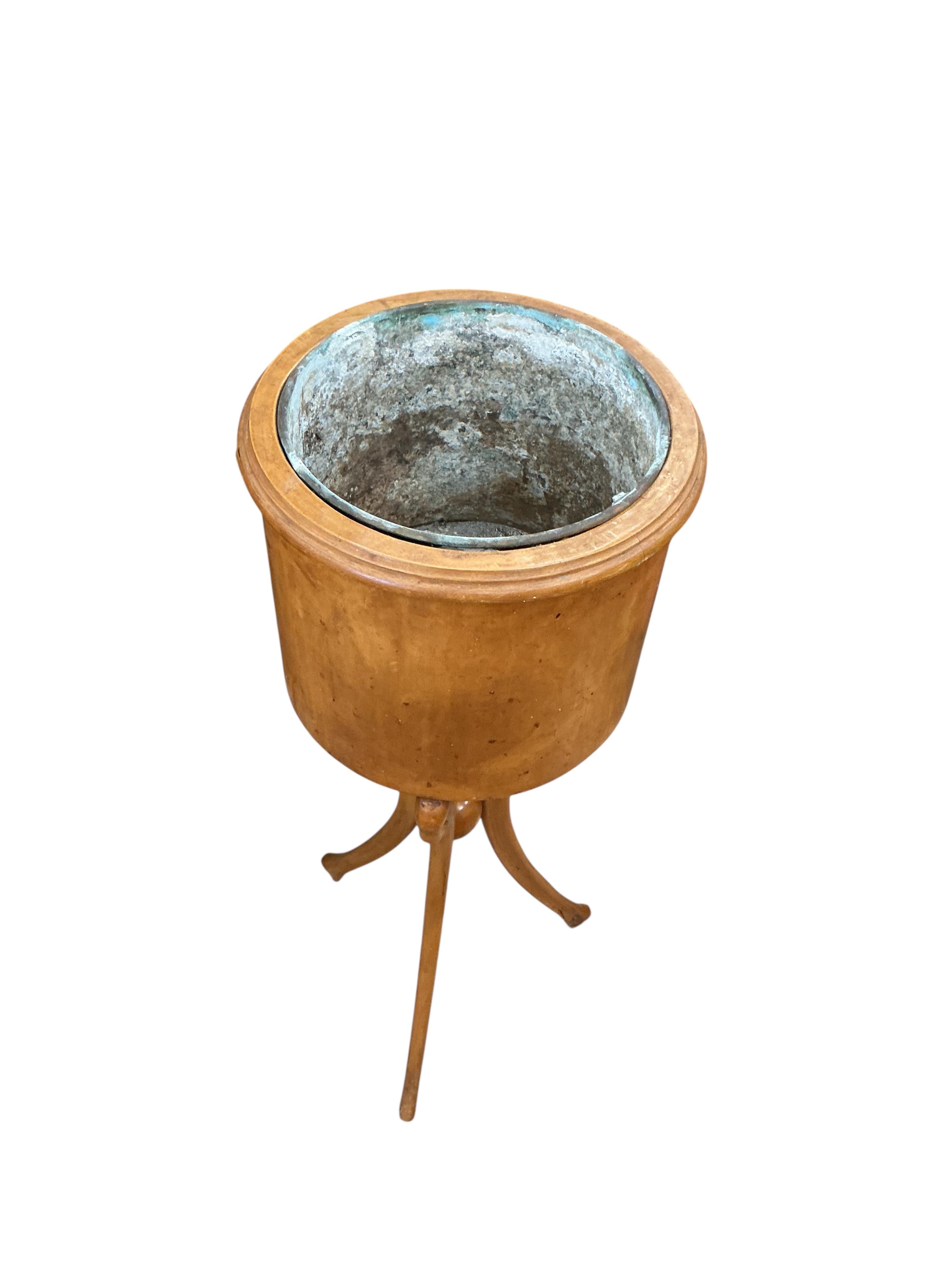 A pair of Empire style circular mahogany jardinieres with swan neck tripod bases, height 83cm